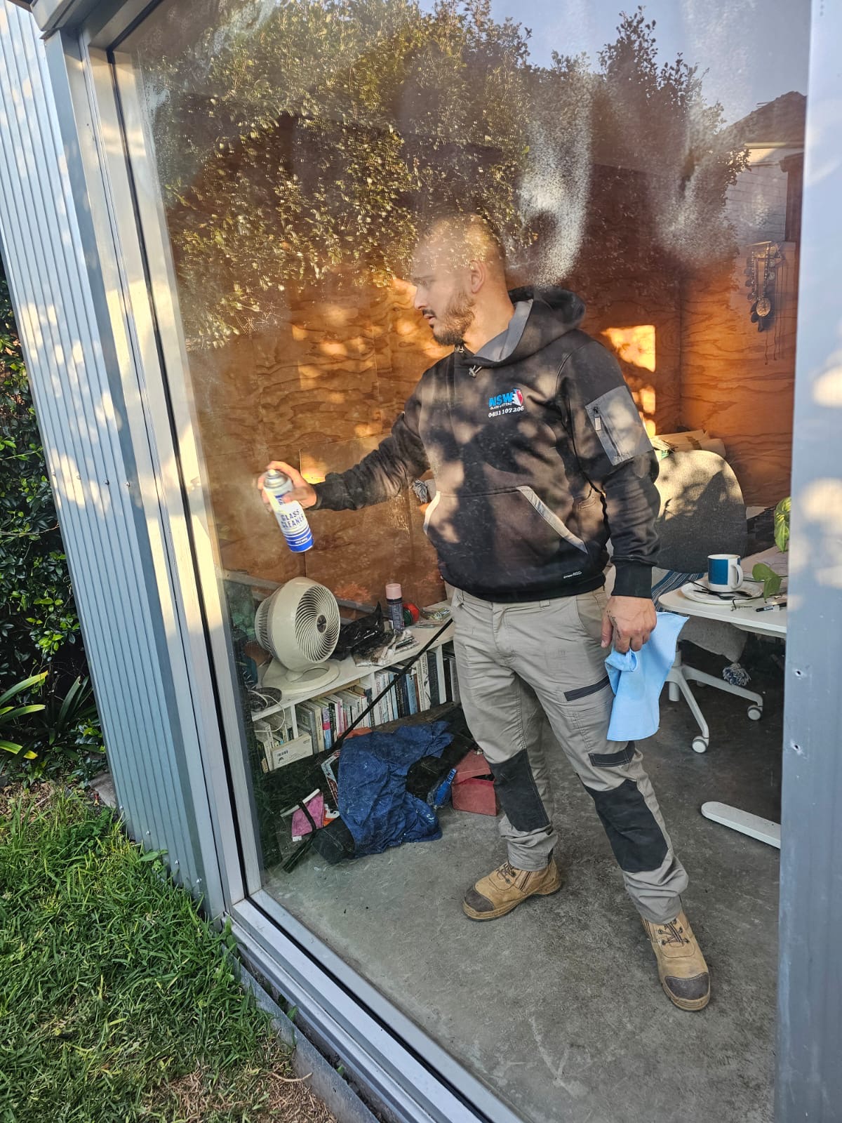 a man standing outside a window