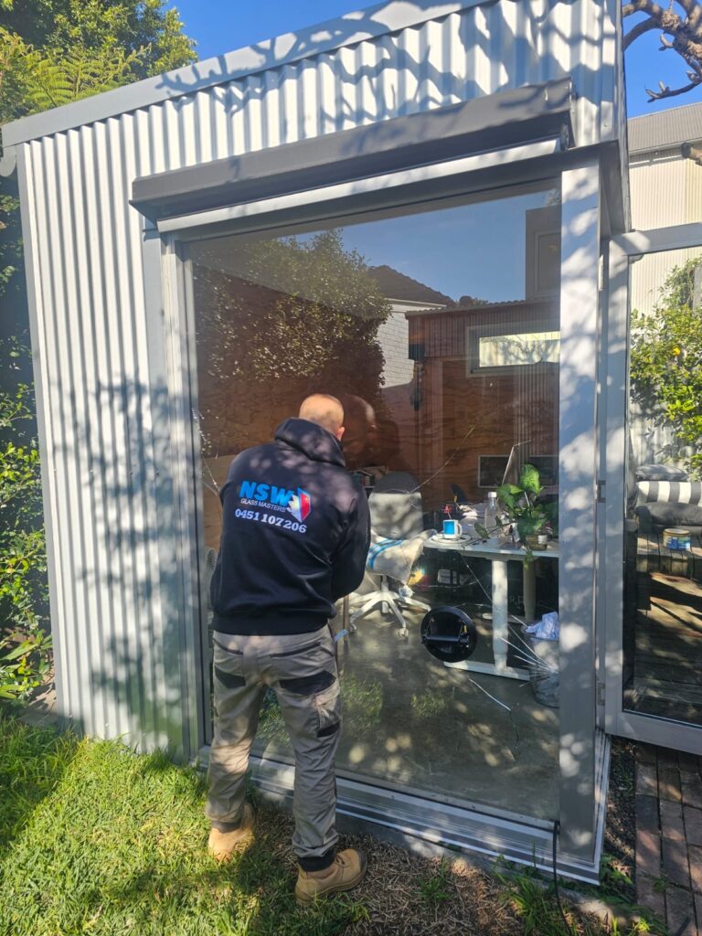 Coogee 5 a man standing in front of a glass door