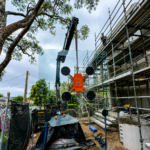 Large commercial glass installation using crane lifting equipment in Sydney