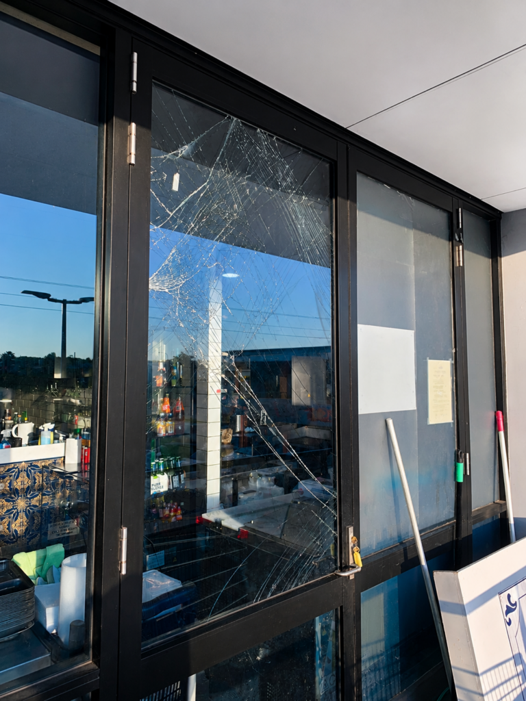 Cracked commercial window glass before emergency replacement by NSW Glass Masters in Sydney.