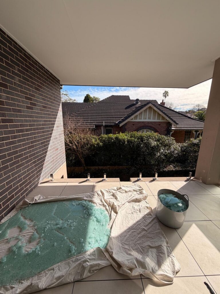 Broken glass balustrade before replacement at a Sydney residential property.