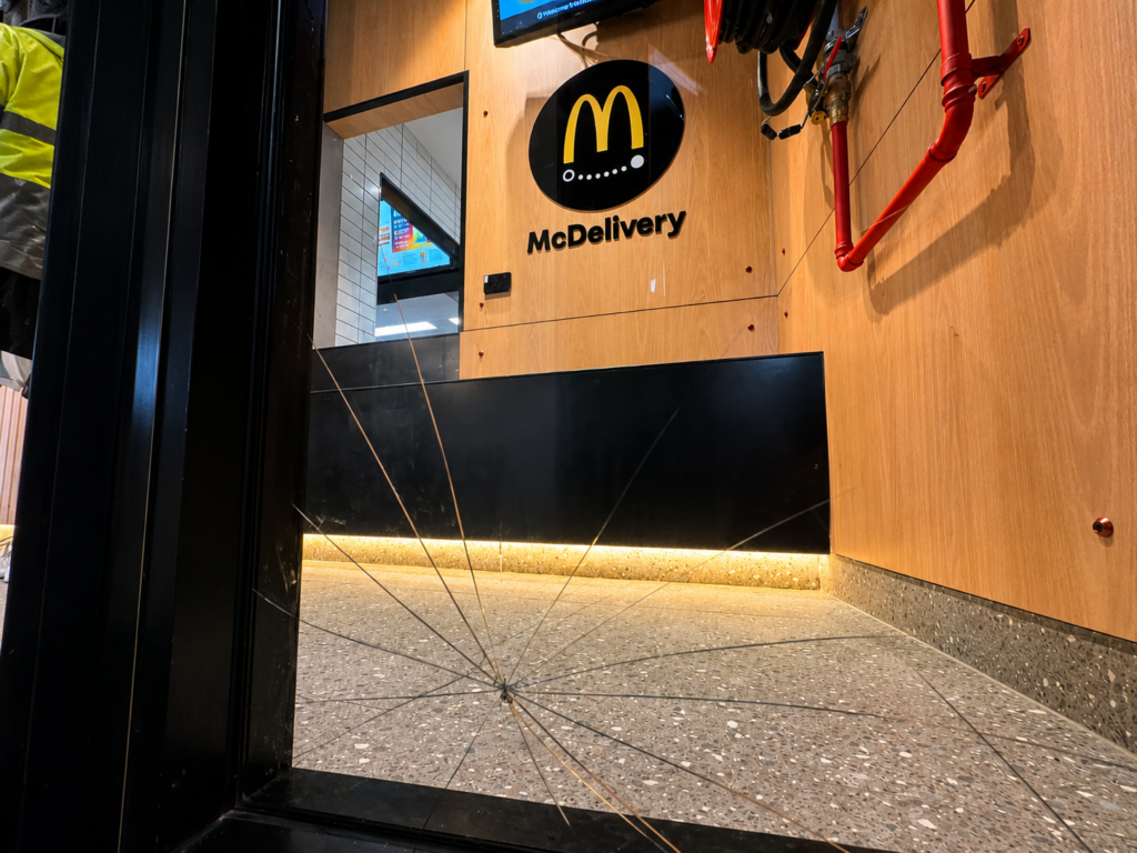 Cracked commercial glass panel before emergency replacement at a Sydney restaurant.